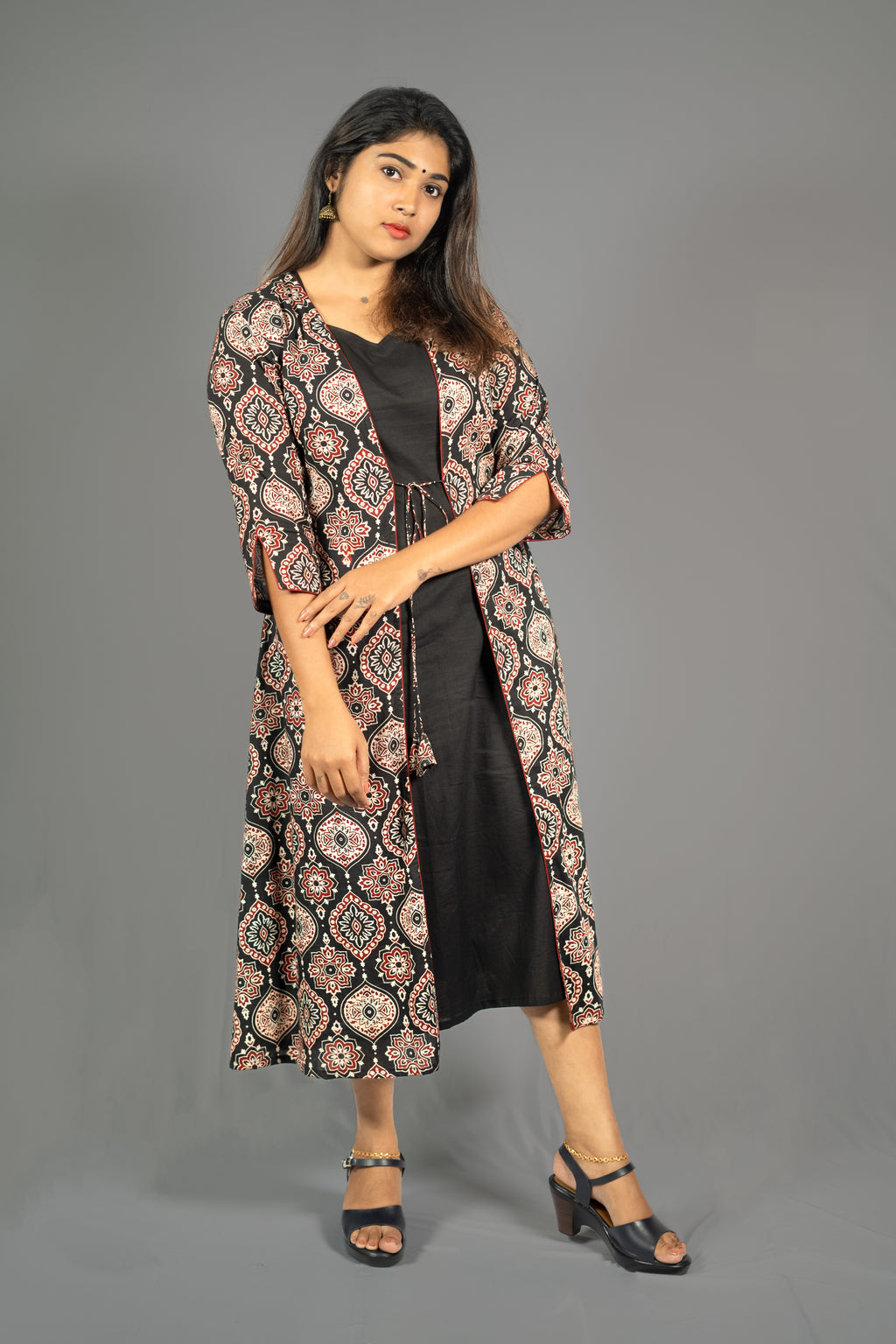 Black women's ethnic co-ord set featuring an A-Line dress with a printed long jacket and stylish sandals