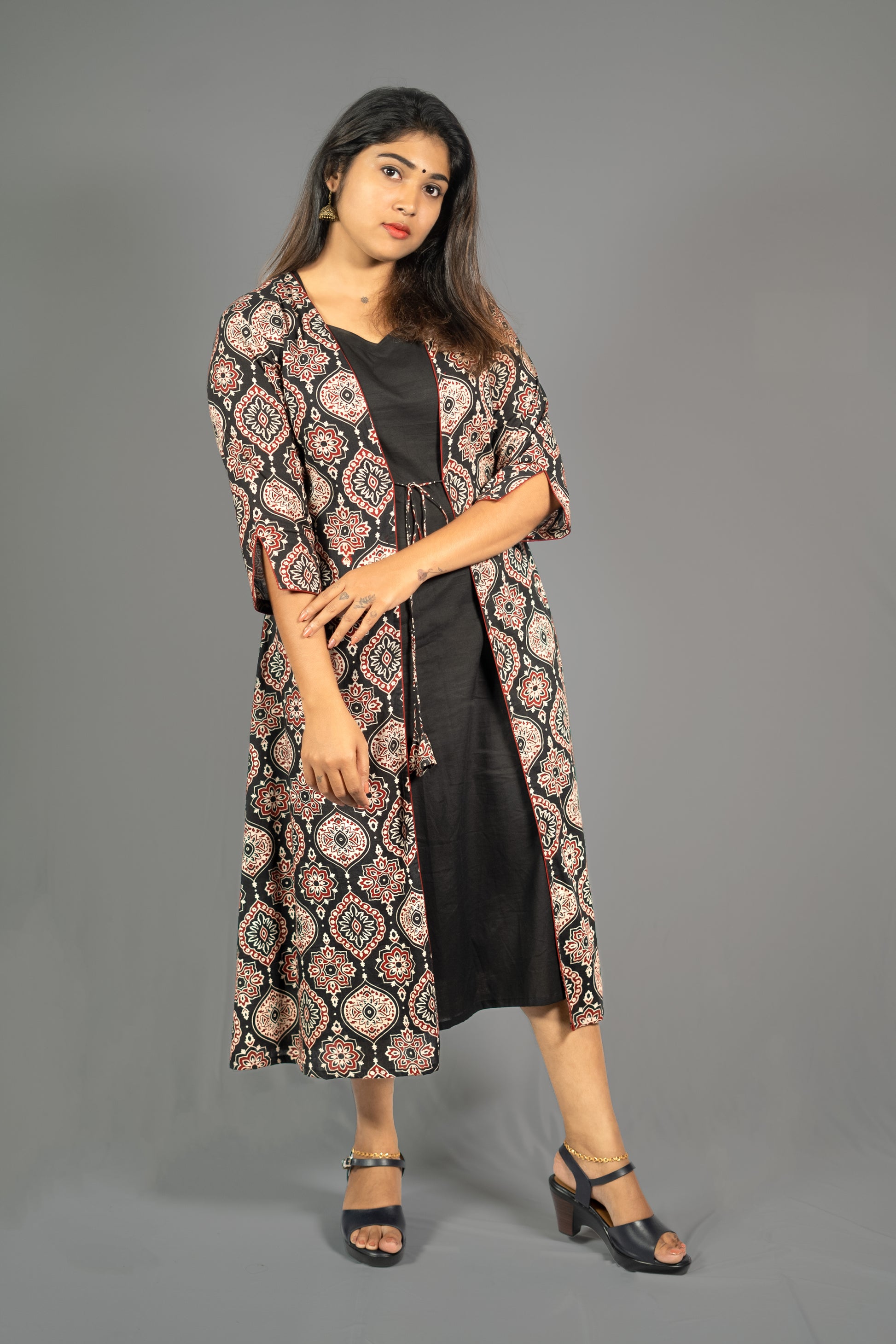 Black women's ethnic co-ord set featuring an A-Line dress with a printed long jacket and stylish sandals