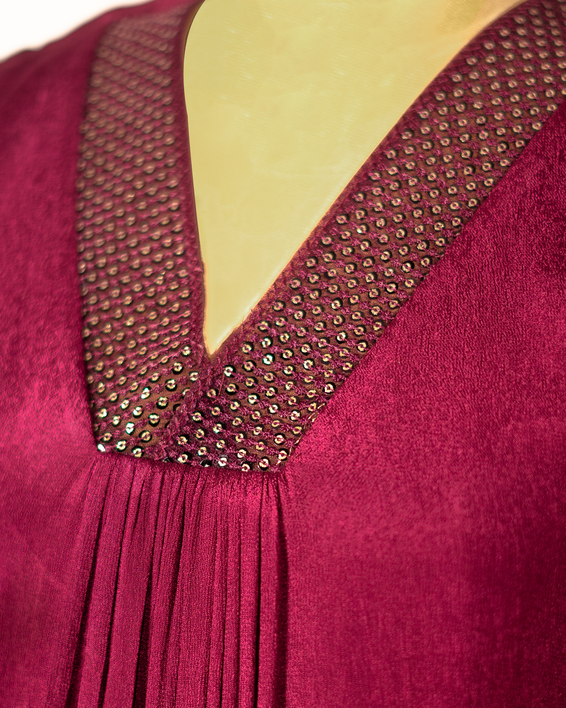 Close-up of Jacinda georgette aline dress for women featuring a pleated V-neck design and embellished neckline