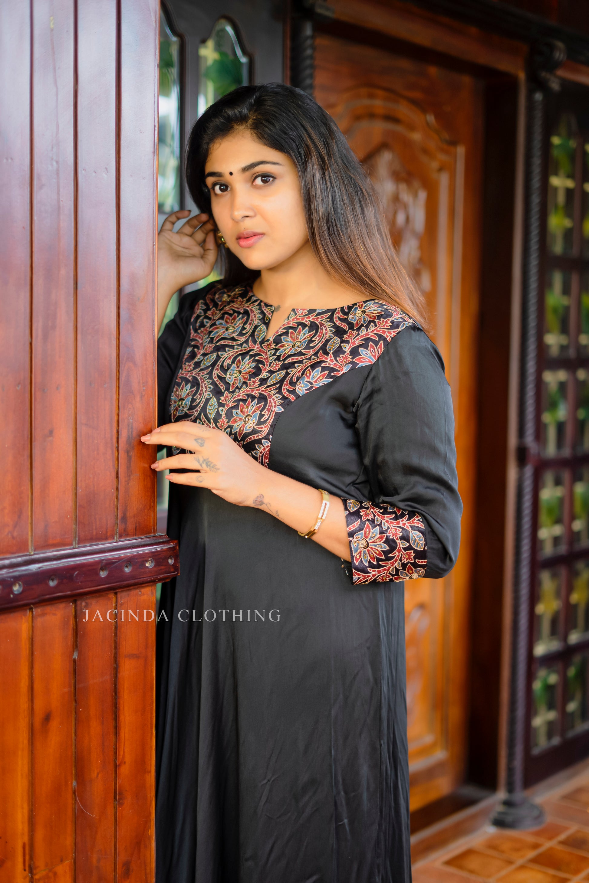 Elegant women's black modal aline dress with intricate floral embroidery on the neckline