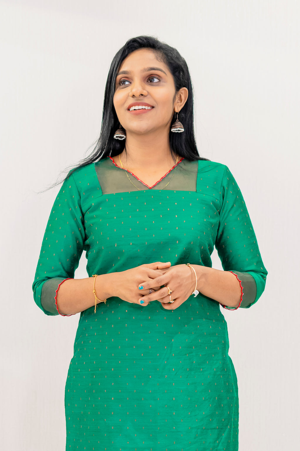 Woman wearing a green cotton party wear set for women with elegant design and subtle detailing
