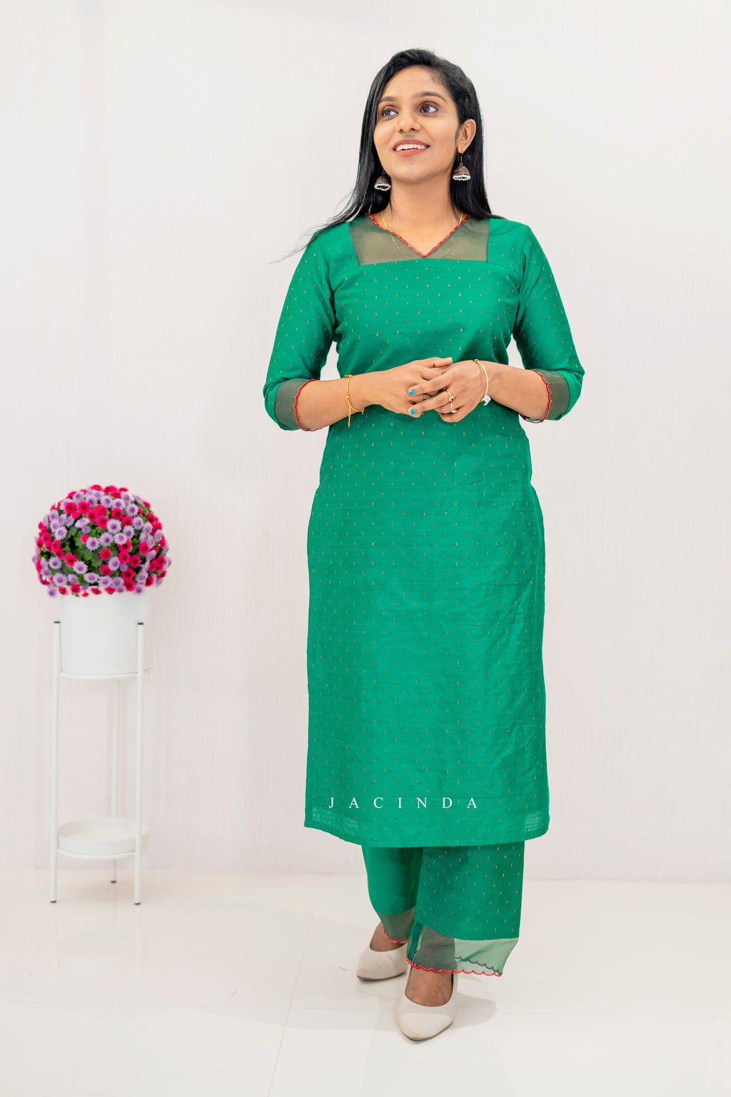 Stylish green cotton party wear set for women featuring a kurta and pants with elegant design