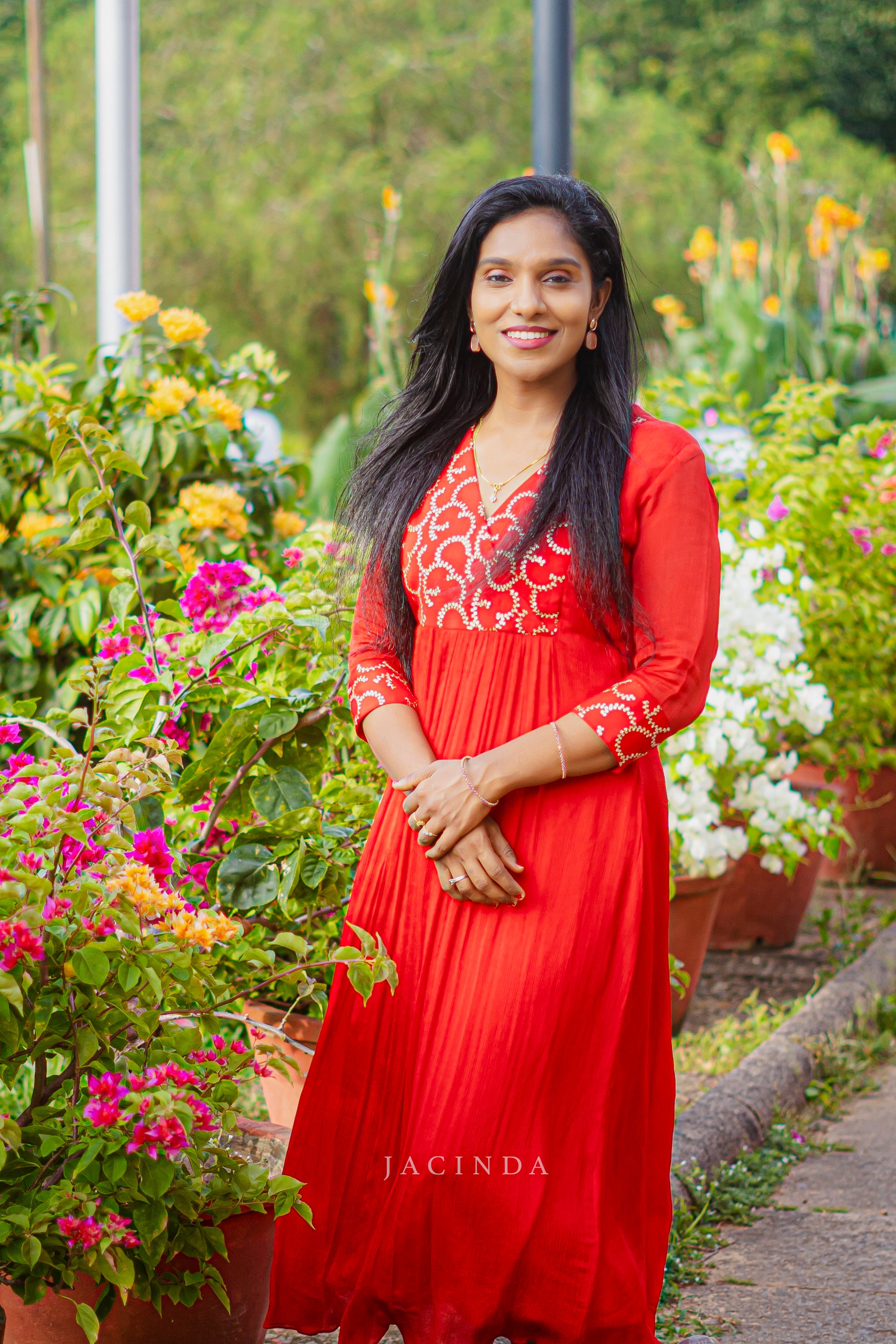 Elegant red georgette party dress by Jacinda featuring intricate embroidery and a flowing silhouette