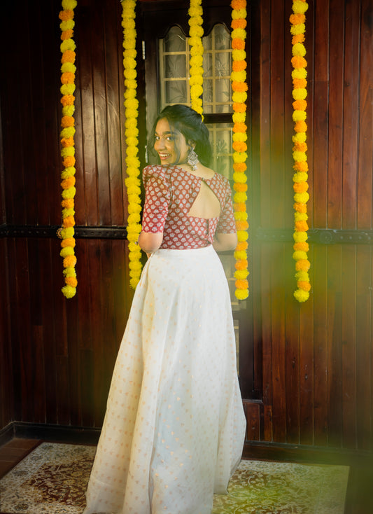 Woman wearing a women's red Ajrakh print crop top paired with a long white skirt by Jacinda
